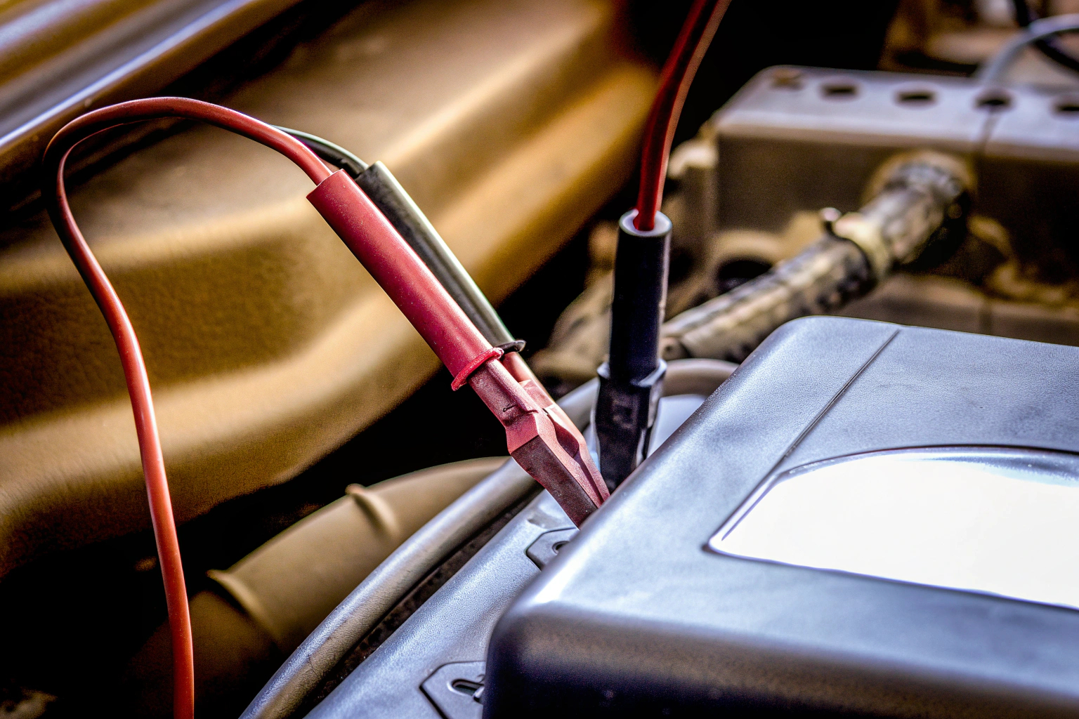 Ein Spannungsprüfer bei der Überprüfung eines Kabels im Motorraum eines Autos. Spannungsprüfer im Einsatz